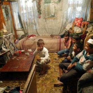 Children in an Uzbek household enjoying football match on television